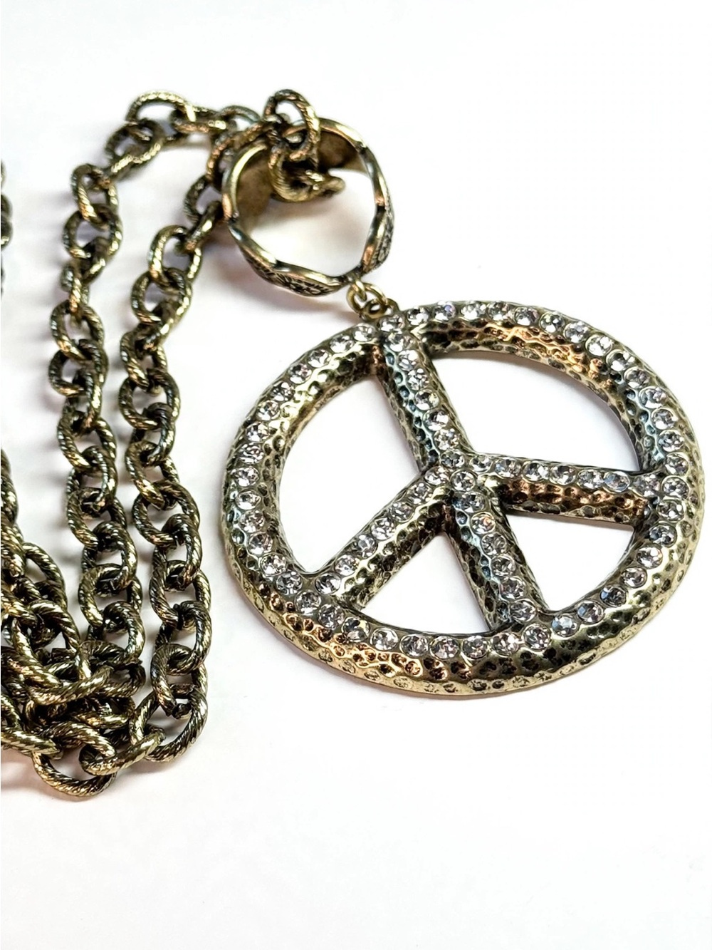 Peace sign in antique gold tone with clear rhinestones on 20” chain